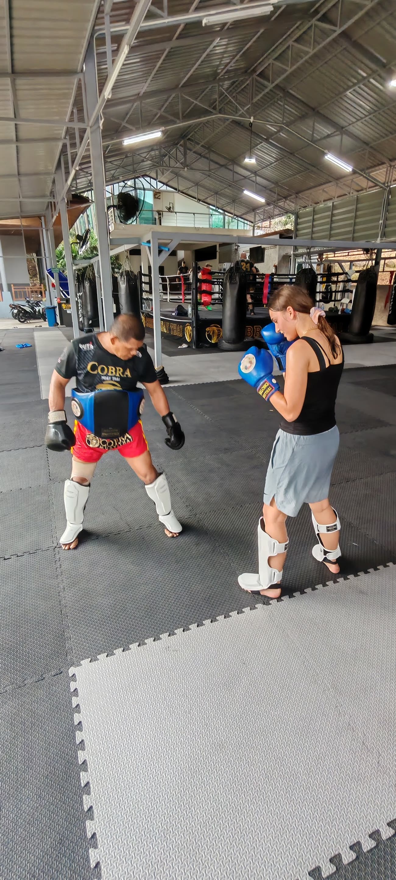 Beginner pad work with a Cobra Muay Thai coach