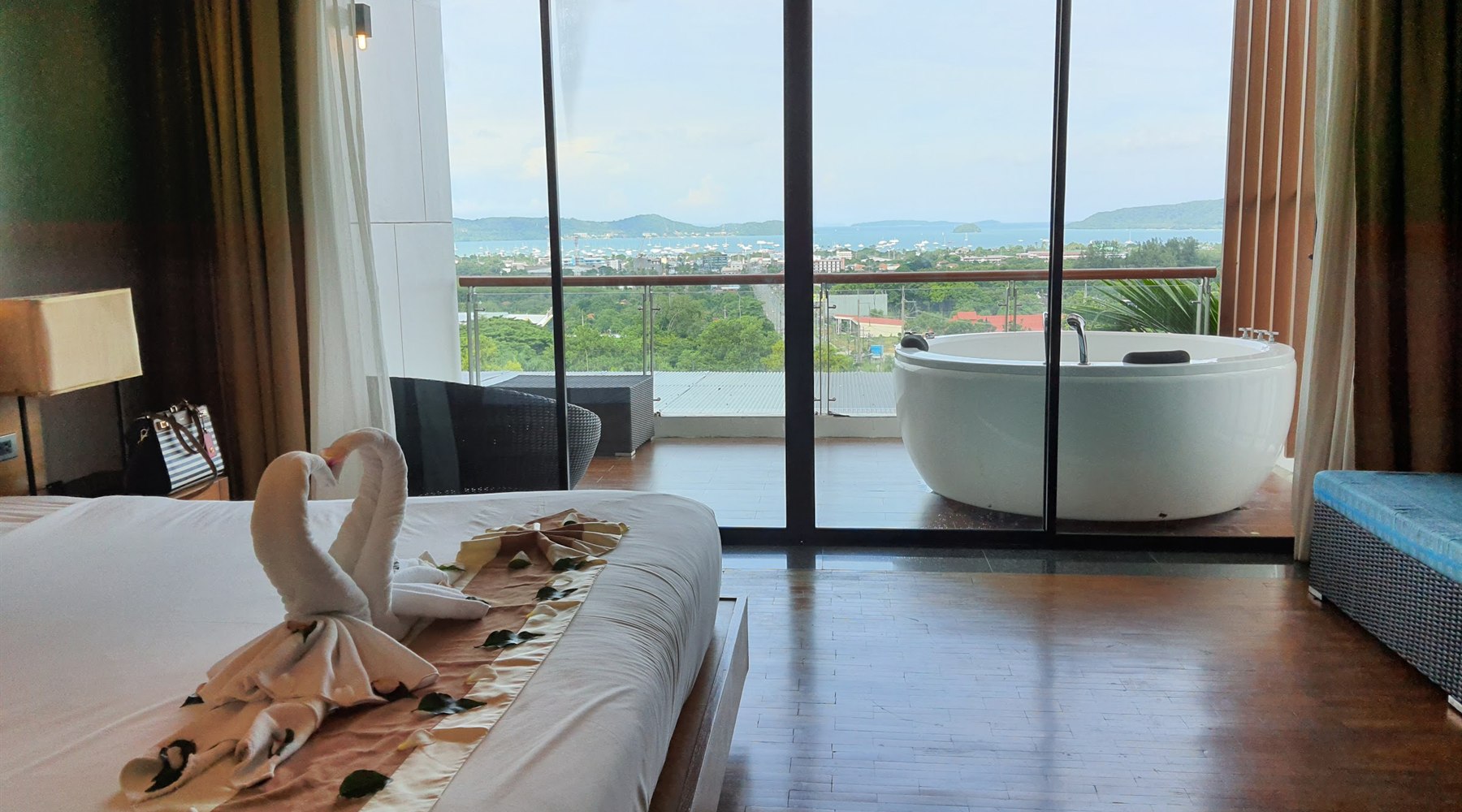 Train and stay room with balcony bath and Chalong Bay view